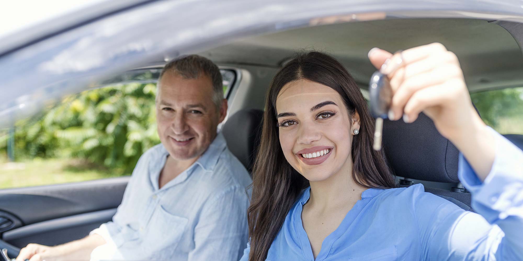 Happy driving student with car keys